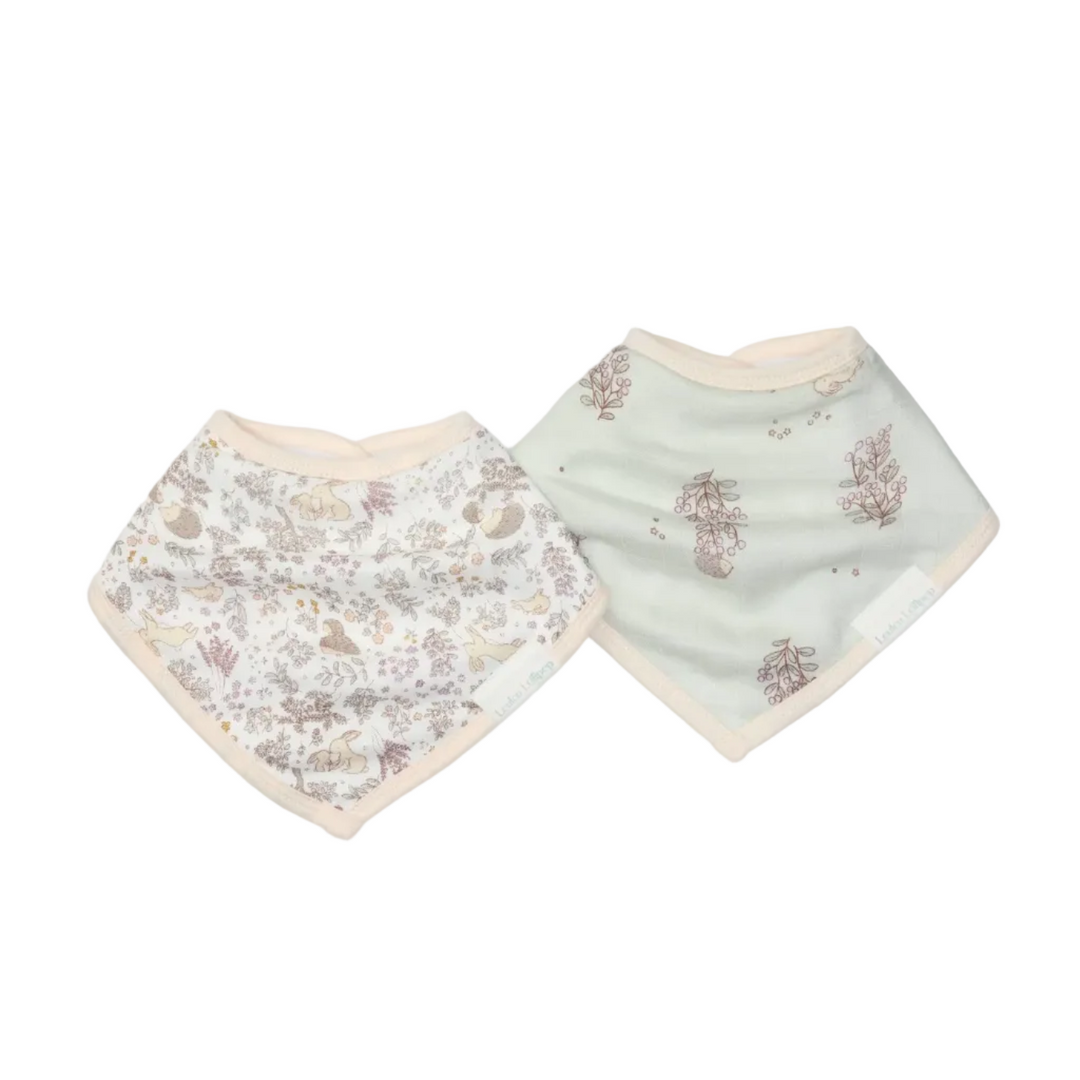 Two baby bibs with floral patterns on a light gray background