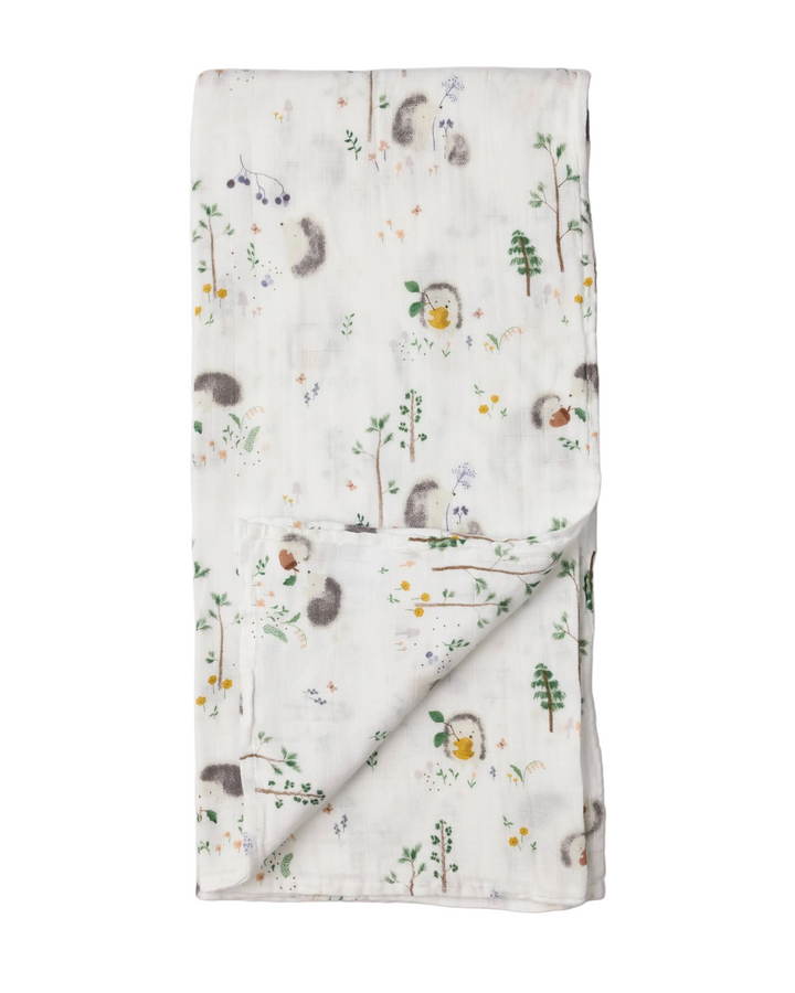 Folded blanket with forest animal pattern on a white background
