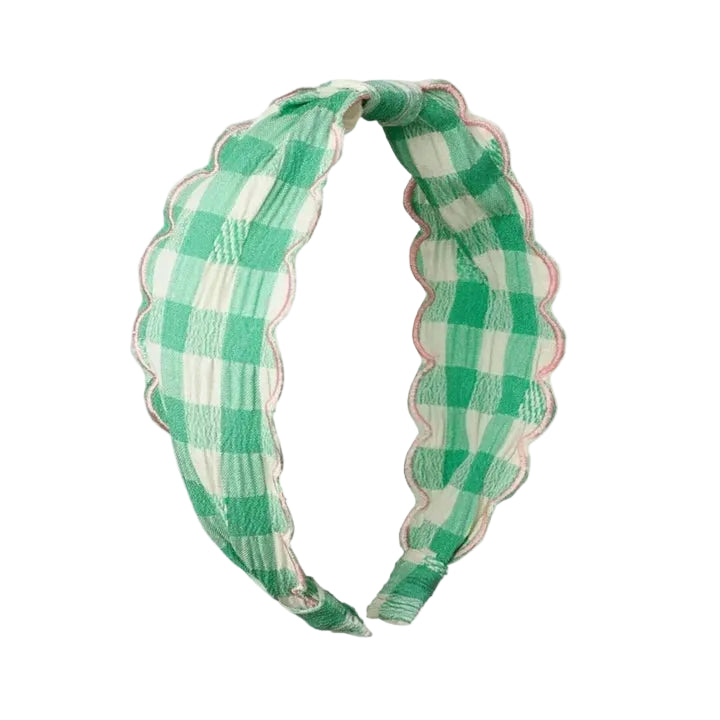 A green and white checkered fabric headband with a scalloped edge, displayed on a solid white background.