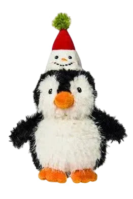A plush toy penguin with black and white feathers, orange beak and feet, wearing a small red Santa hat with a green pom-pom, isolated on a white background.