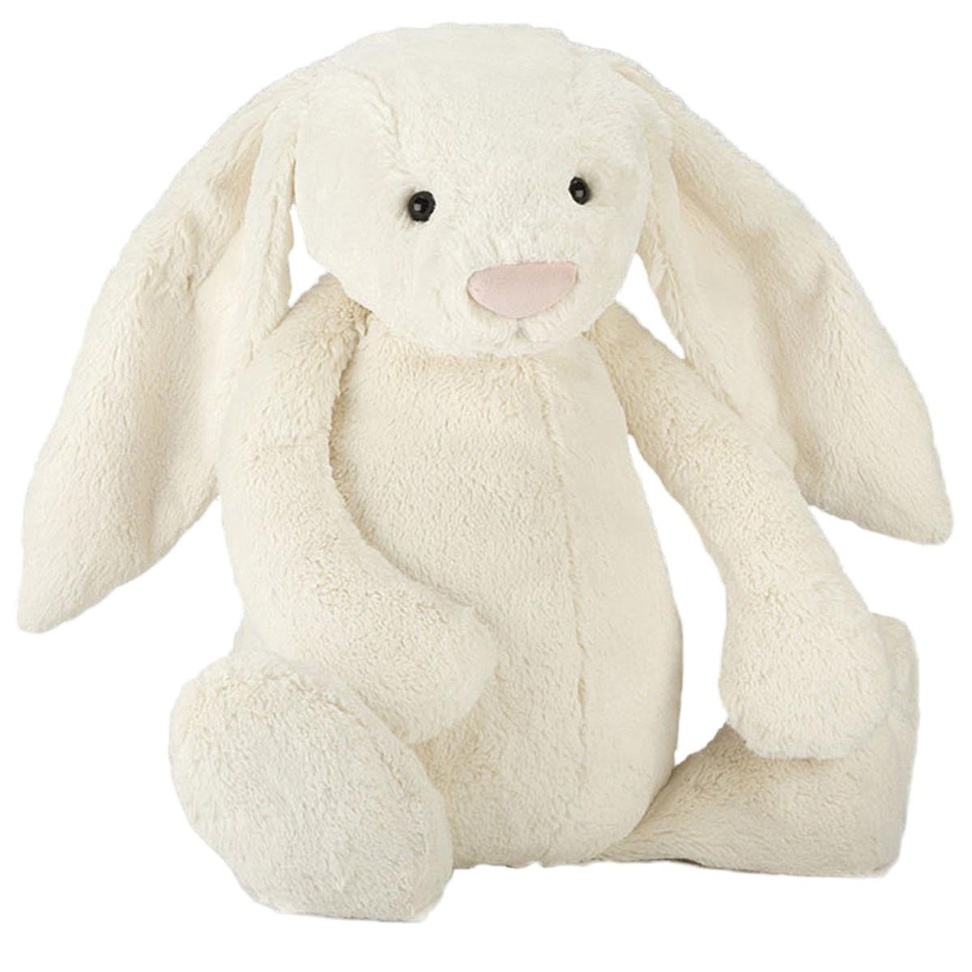 A plush toy resembling a cream-colored bunny with a soft, fluffy texture. The bunny has a smiling face, long ears, and a pink nose.
